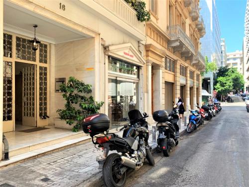 a row of motorcycles parked on the side of a street at GK Niki by GK Properties in Athens
