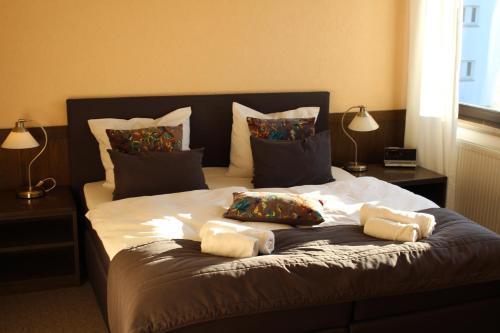 a bed with two pillows on top of it at Hotel Brunnenhof in Bad Nauheim