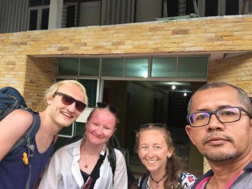a group of people standing in front of a building at DAOH'S Rooms & Scooters in Tanjung Rhu 