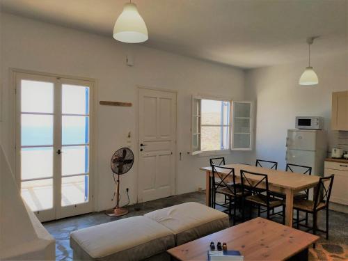 a living room with a table and a kitchen at Vitali Beach Houses in Andros