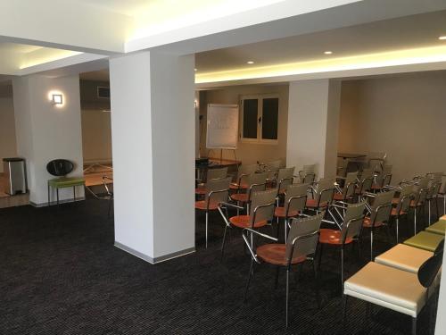 a conference room with chairs and a white pole at Hotel Levadia in Levádeia