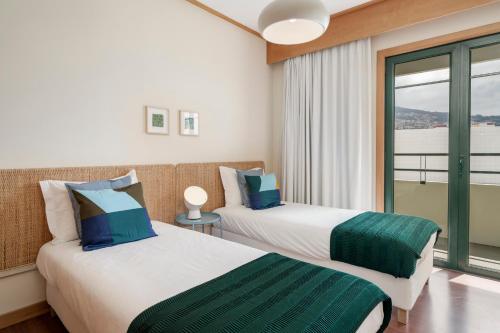 Ένα ή περισσότερα κρεβάτια σε δωμάτιο στο Ilhéus V by An Island Apart