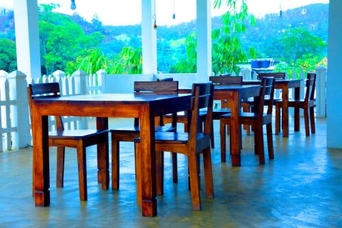 a group of wooden tables and chairs in a room at Alrich Ella in Ella