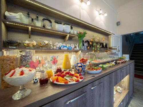 a buffet with plates of food on a counter at Hotel Boritzka in Hamburg