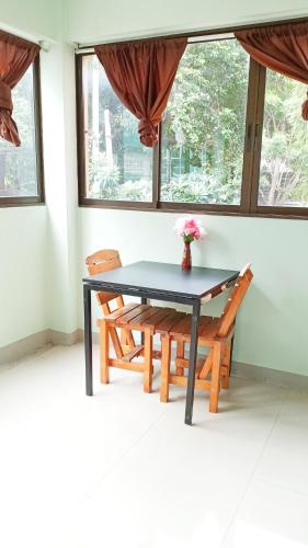 a dining room with a table and two chairs at Banyan Resort Bangsaen in Bangsaen