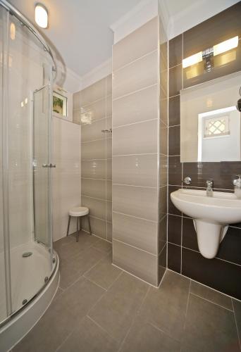 a bathroom with a sink and a shower at Várkapu Apartman in Eger