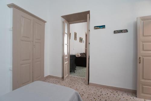 a bedroom with a door leading into a room at Chez Georges in Parikia