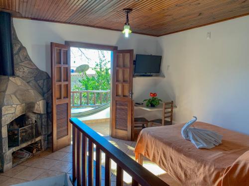 Ένα ή περισσότερα κρεβάτια σε δωμάτιο στο Pousada Arco-Íris