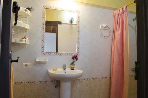 un baño con lavabo y espejo en Vivelorural casa en Valle de Chira con piscina, en San Bartolomé