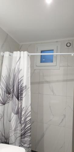 a bathroom with a window and a towel at Chriselia in Nea Roda