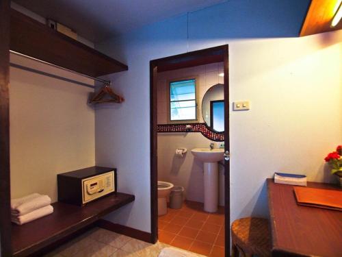 a bathroom with a sink and a toilet and a mirror at P.P. Casita - Adult Only in Phi Phi Islands