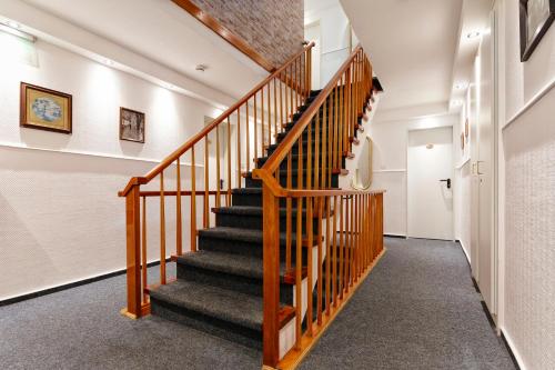 a staircase in a house with wooden railings at Hotel Helgolandia in Helgoland