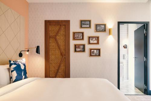 a bedroom with a bed and pictures on the wall at Mercure Marseille Canebière Vieux-Port in Marseille