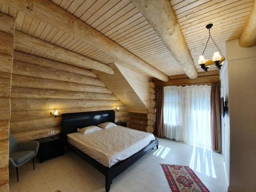 a bedroom with wooden walls and a bed in a room at Casa Cartianu in Târgu Jiu