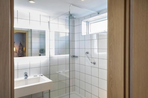 a bathroom with a shower and a sink at Mercure Cardiff North Hotel in Cardiff