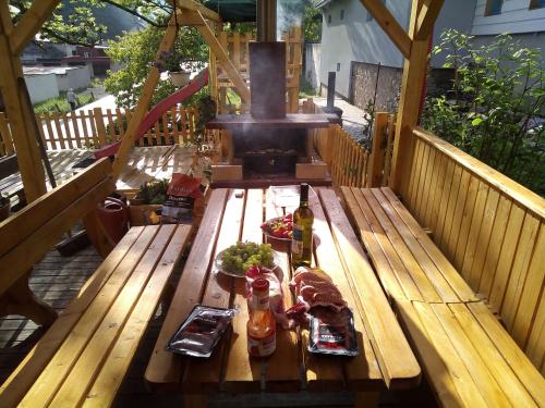 a picnic table with food and drinks on a deck at Pension nad Truhlárnou in Svoboda nad Úpou