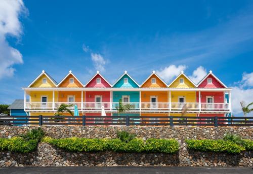 a row of red and white houses on a hillside at Bed & Bike Curacao - Jan Thiel in Willemstad