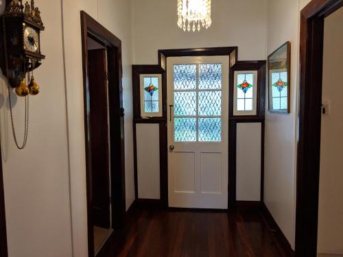 a hallway with a door and stained glass windows at Walnut Cottage - 2 bedroom pet friendly country cottage in Bridgetown