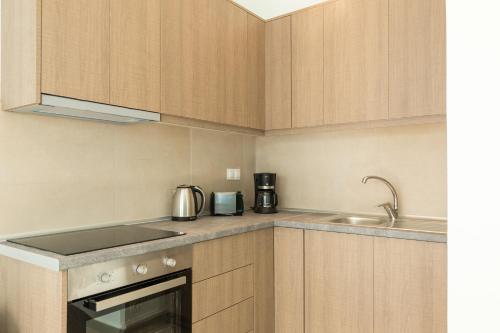 a kitchen with a sink and a counter top at Local Hostel & Suites in Corfu Town
