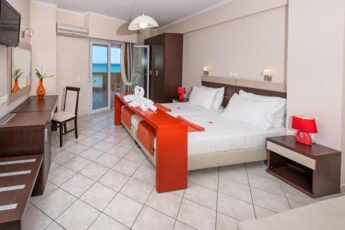 a hotel room with a bed and a desk and a desk at Al Mare Hotel in Tsilivi
