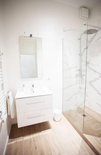 une salle de bain blanche avec un lavabo et une douche dans l'établissement Magnifique 2 pieces frontiere Monaco, à Beausoleil