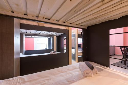 a bedroom with a bed with a large window at Local Hostel & Suites in Corfu Town