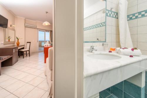a bathroom with a sink in a room at Al Mare Hotel in Tsilivi