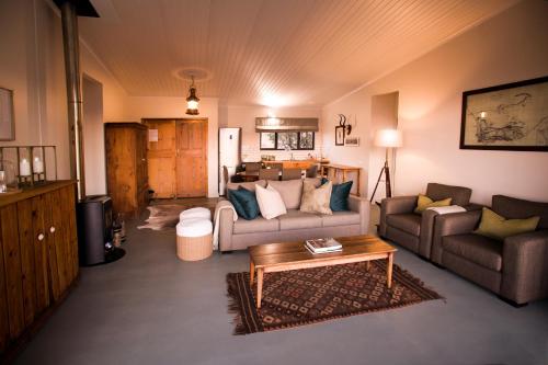 a living room with a couch and a coffee table at Three Tree Hill Lodge in Bergville