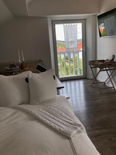 a bedroom with a bed and a sliding glass door at Haus Grünewald Unsleben in Unsleben