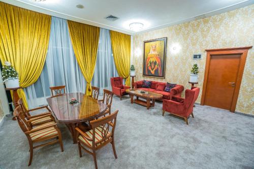 a living room with a couch and a table and chairs at Hotel San Terme Laktaši in Laktaši