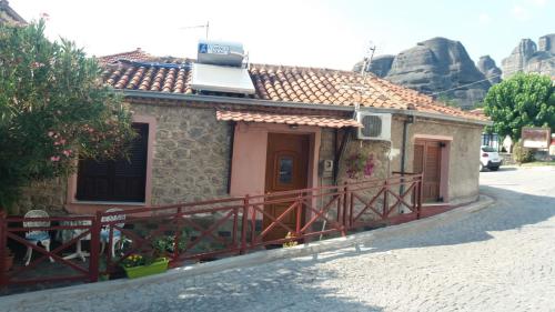 a small house with a sign on top of it at Yiannis House in Kalabaka