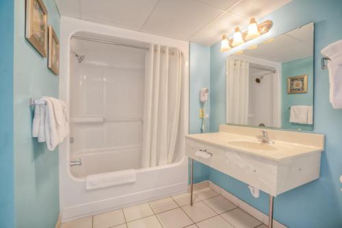 a bathroom with a sink and a shower at Sand Dunes Resort & Suites in Myrtle Beach