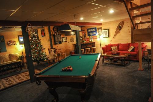 a living room with a pool table and a christmas tree at Mink Hollow Lodge in Elka Park