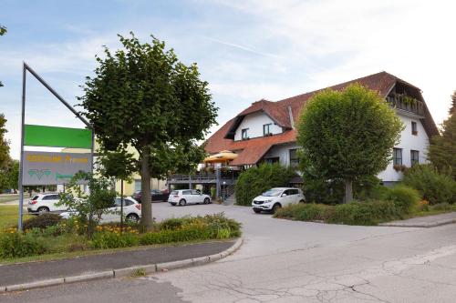 a parking lot with cars parked in front of a building at Gostišče Prosnik in Ormoz