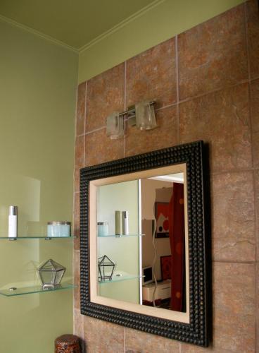 a mirror on a wall in a room at L ESCALE EN BEAUCE in Maisons