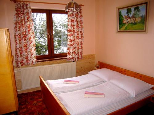 Ένα ή περισσότερα κρεβάτια σε δωμάτιο στο Chalupa Vysoke Tatry