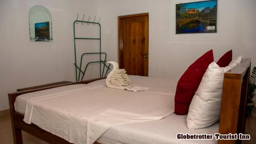 Ένα ή περισσότερα κρεβάτια σε δωμάτιο στο Globetrotter Tourist Inn