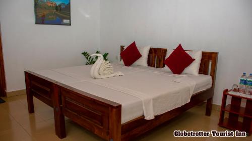 Ένα ή περισσότερα κρεβάτια σε δωμάτιο στο Globetrotter Tourist Inn