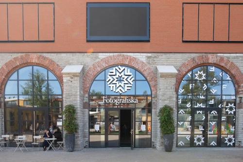 a store front with two arched windows and a sign at Economy Hotel in Tallinn
