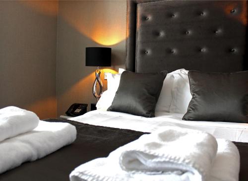 a bedroom with two beds with white sheets and pillows at The Bold Hotel; BW Signature Collection in Southport