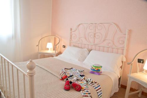 a bedroom with a bed with red shoes on it at Agriturismo Ai Carpini in Marcon