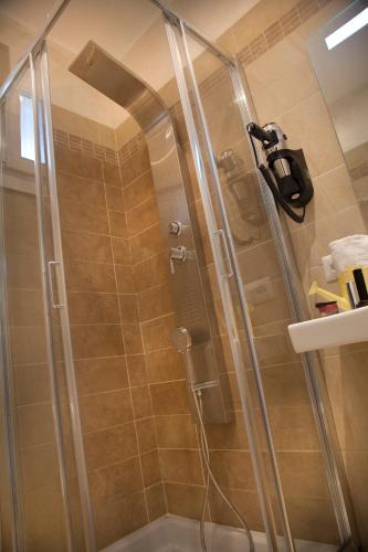 a shower with a glass door in a bathroom at Hotel Vienna Ostenda e Ristorante il Danubio in Rimini