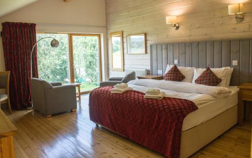 a bedroom with a large bed in a room at Brathay Hall - Brathay Trust in Ambleside
