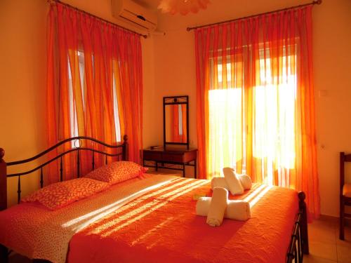 a bedroom with a bed with two teddy bears on it at Four Seasons 1 in Paralia Katerinis