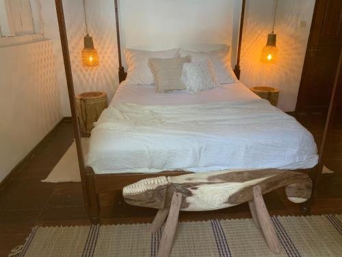 a bedroom with a large bed with a wooden frame at Villa Voanio in Ile aux Nattes
