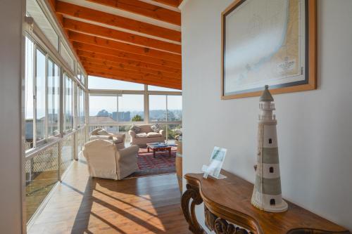 a living room with a lighthouse on the wall at Kai Bed and Breakfast in Algarrobo