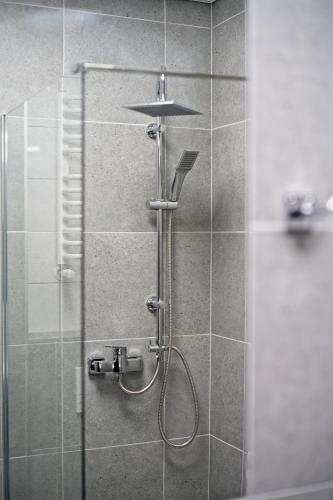 a shower in a bathroom with a glass door at S7 Hotel in Kielce