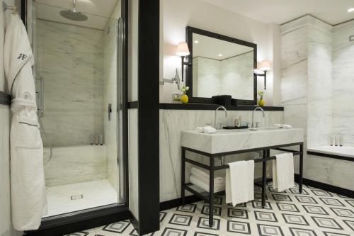 a bathroom with a sink and a shower at Rocco Forte Hotel De La Ville in Rome