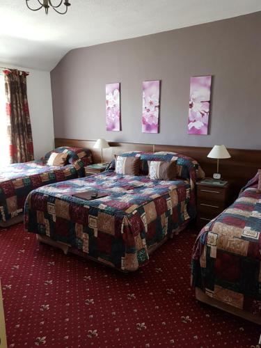 a hotel room with two beds in a room at Karden House in Llandudno