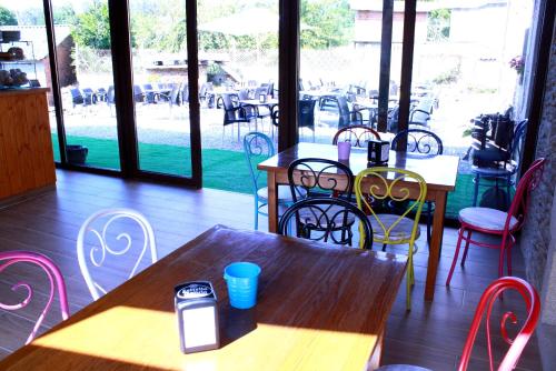 a restaurant with tables and chairs with a cell phone on it at Casa do Horreo in O Pino 